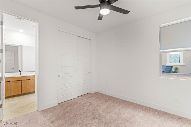 10851 Hanwicke Harbor Ave, Las Vegas, NV 89166 - unfurnished bedroom featuring light carpet, a closet, baseboards, and ensuite bath