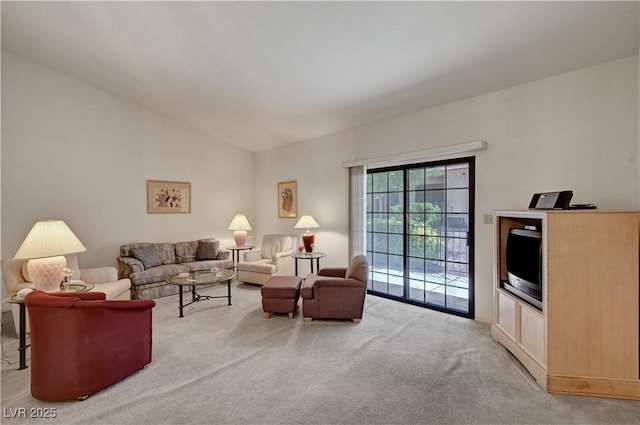 carpeted living room with lofted ceiling