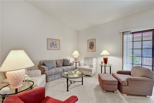 carpeted living area featuring lofted ceiling