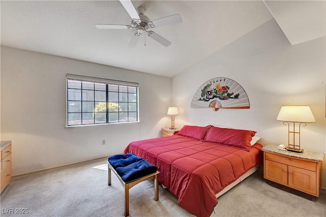 bedroom featuring light colored carpet, baseboards, and a ceiling fan