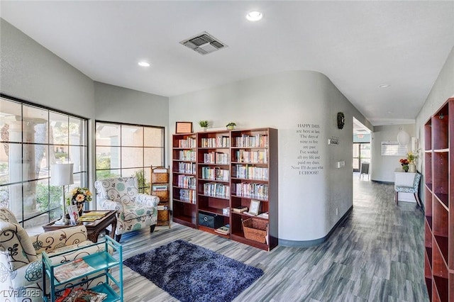 living area featuring wood finished floors, baseboards, and recessed lighting