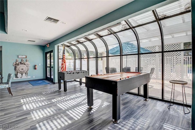 game room with french doors, baseboards, and wood finished floors