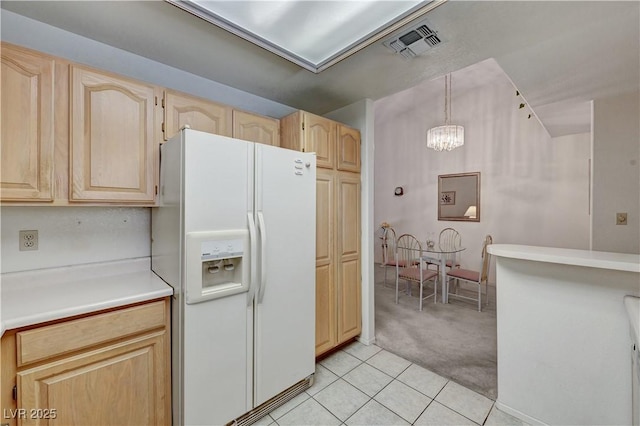 kitchen featuring white fridge with ice dispenser, light brown cabinetry, light carpet, a chandelier, and light tile patterned floors