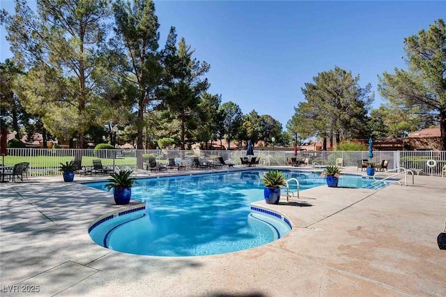 community pool featuring fence and a patio