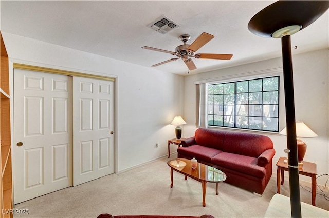 living room featuring carpet floors, ceiling fan, and baseboards