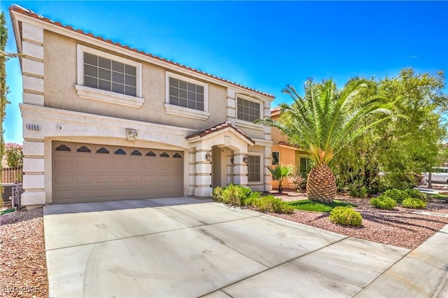 6559 Musette Ave, Las Vegas, NV 89139 - view of front of property featuring stucco siding, driveway, an attached garage, and a tile roof