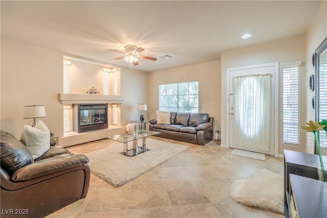 6559 Musette Ave, Las Vegas, NV 89139 - living area with a glass covered fireplace and a ceiling fan