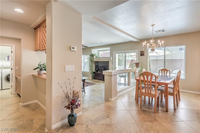 6559 Musette Ave, Las Vegas, NV 89139 - dining area with washer / clothes dryer, a chandelier, baseboards, and light tile patterned flooring