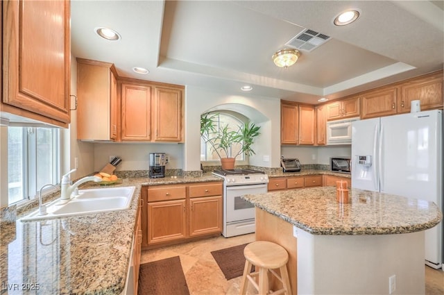 6559 Musette Ave, Las Vegas, NV 89139 - kitchen featuring white appliances, a sink, a raised ceiling, a kitchen island, and recessed lighting