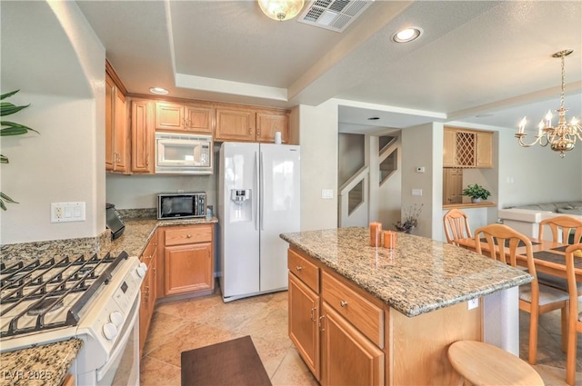 6559 Musette Ave, Las Vegas, NV 89139 - kitchen featuring white appliances, light stone counters, recessed lighting, a center island, and a raised ceiling