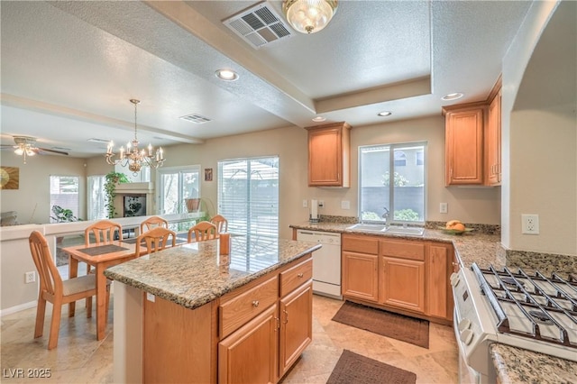 6559 Musette Ave, Las Vegas, NV 89139 - kitchen featuring gas stove, white dishwasher, a sink, a textured ceiling, and a center island