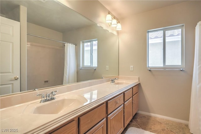 6559 Musette Ave, Las Vegas, NV 89139 - bathroom featuring baseboards, double vanity, and tile patterned flooring