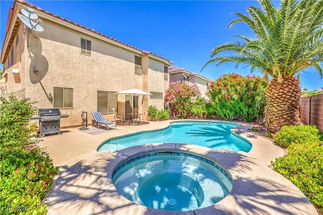 6559 Musette Ave, Las Vegas, NV 89139 - view of swimming pool with a patio area, grilling area, a pool with connected hot tub, and a fenced backyard