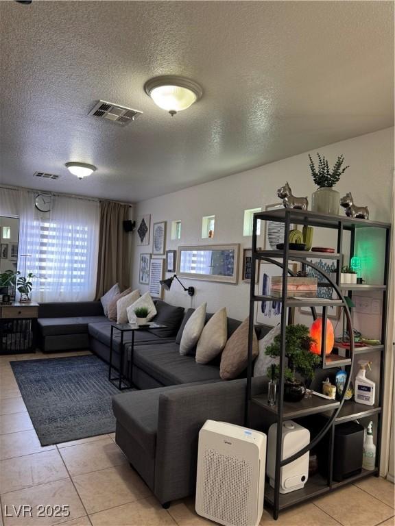 living room featuring a textured ceiling and tile patterned flooring
