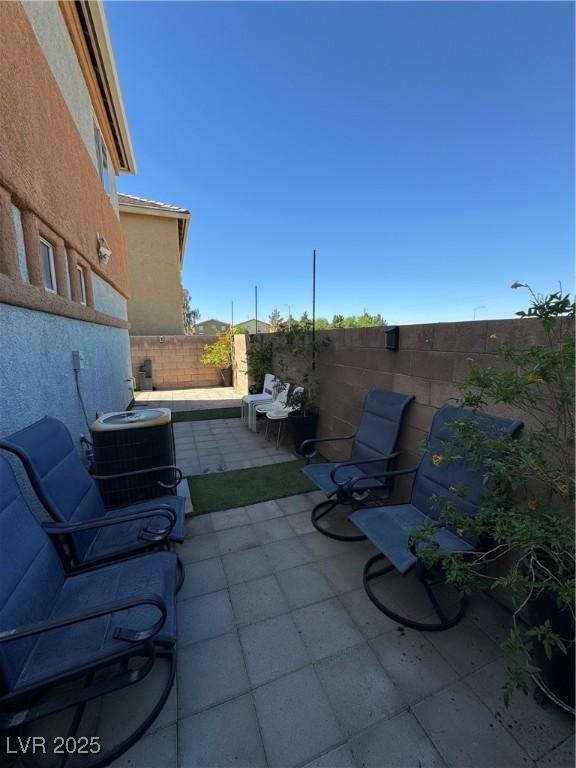 view of patio featuring central AC unit and a fenced backyard