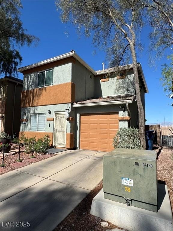 view of front of property with stucco siding, concrete driveway, and an attached garage