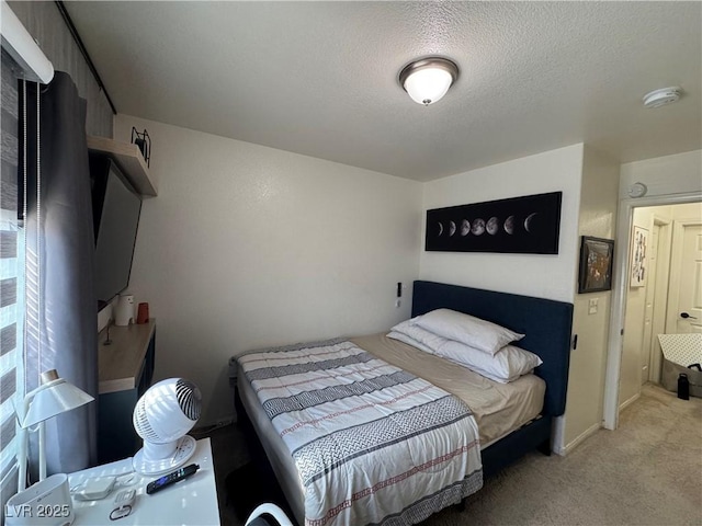 bedroom with carpet and a textured ceiling