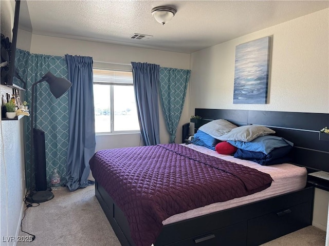 carpeted bedroom featuring a textured ceiling