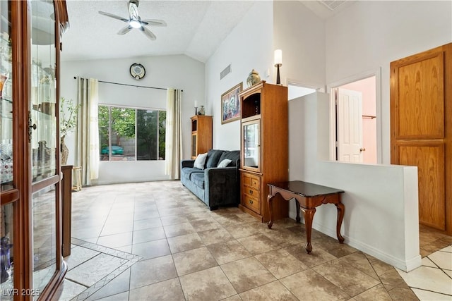 mudroom featuring ceiling fan, light tile patterned flooring, high vaulted ceiling, and baseboards