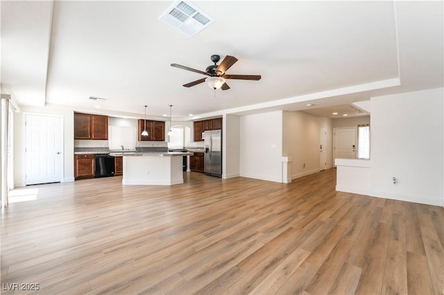 6821 Treble Clef Ave, Las Vegas, NV 89139 - unfurnished living room featuring ceiling fan, light wood finished floors, recessed lighting, baseboards, and a raised ceiling