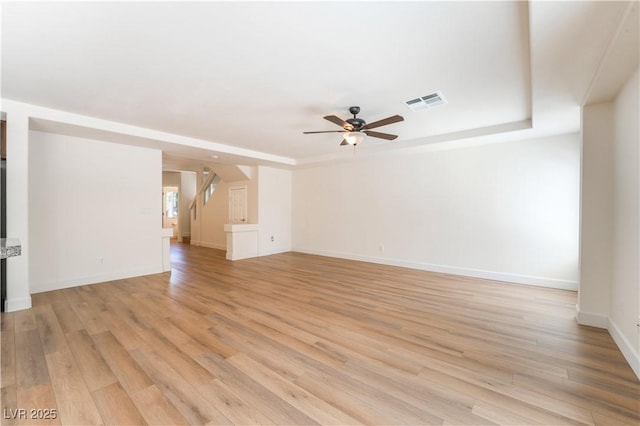 6821 Treble Clef Ave, Las Vegas, NV 89139 - spare room featuring a ceiling fan, light wood finished floors, baseboards, and a raised ceiling