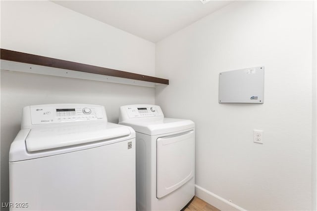 6821 Treble Clef Ave, Las Vegas, NV 89139 - laundry room with separate washer and dryer, baseboards, and light wood-type flooring