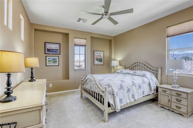 5650 Pleasant Palms St, North Las Vegas, NV 89081 - bedroom with light colored carpet, multiple windows, baseboards, and a ceiling fan
