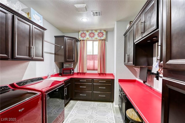 5650 Pleasant Palms St, North Las Vegas, NV 89081 - laundry room with cabinet space, washer and dryer, and a textured ceiling