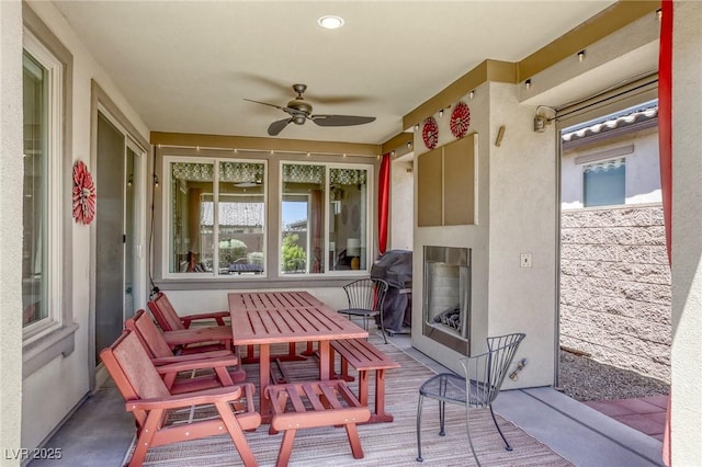 5650 Pleasant Palms St, North Las Vegas, NV 89081 - view of patio / terrace with exterior fireplace, a ceiling fan, and outdoor dining space
