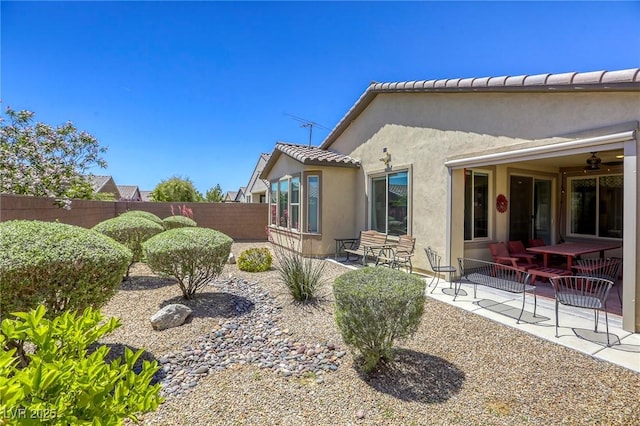 5650 Pleasant Palms St, North Las Vegas, NV 89081 - view of side of home with fence, stucco siding, and a patio area