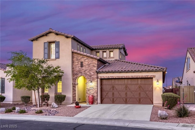 5650 Pleasant Palms St, North Las Vegas, NV 89081 - mediterranean / spanish house featuring a garage, driveway, a tiled roof, stucco siding, and fence