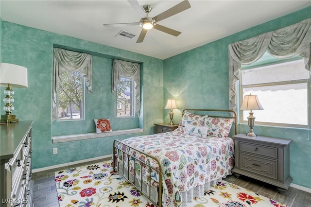 5650 Pleasant Palms St, North Las Vegas, NV 89081 - bedroom featuring multiple windows, wood tiled floors, baseboards, and ceiling fan