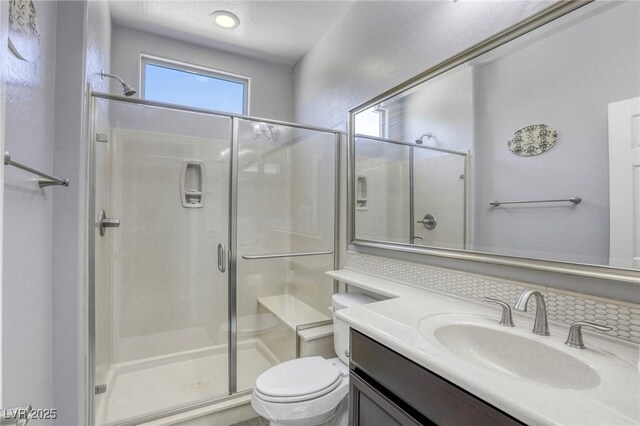 5650 Pleasant Palms St, North Las Vegas, NV 89081 - bathroom featuring a stall shower, toilet, and vanity