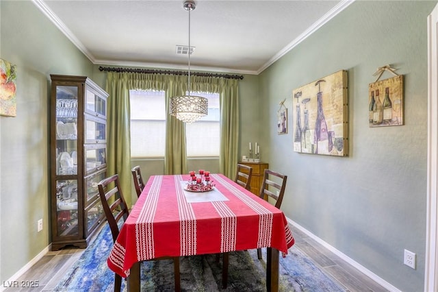 5650 Pleasant Palms St, North Las Vegas, NV 89081 - dining room with wood finished floors, a chandelier, ornamental molding, and baseboards