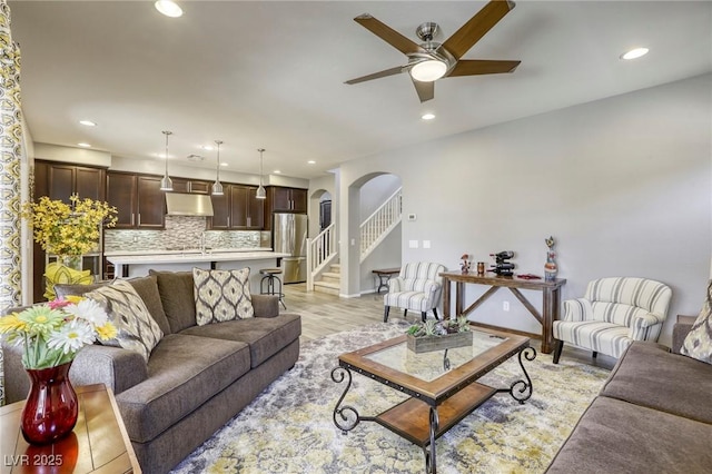 5650 Pleasant Palms St, North Las Vegas, NV 89081 - living room with arched walkways, a ceiling fan, recessed lighting, baseboards, and light wood-style flooring