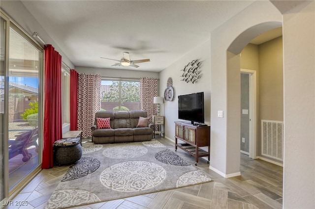 5650 Pleasant Palms St, North Las Vegas, NV 89081 - living room with ceiling fan, arched walkways, and baseboards