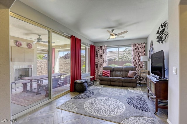 5650 Pleasant Palms St, North Las Vegas, NV 89081 - living room featuring ceiling fan and a fireplace