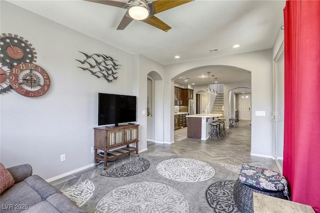5650 Pleasant Palms St, North Las Vegas, NV 89081 - living area featuring arched walkways, baseboards, a ceiling fan, and recessed lighting