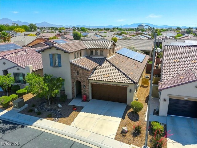 5650 Pleasant Palms St, North Las Vegas, NV 89081 - view of front of home with a residential view, stucco siding, a tiled roof, an attached garage, and driveway