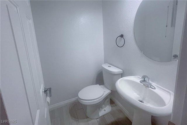 9148 Alluring Ave, Las Vegas, NV 89149 - half bath featuring a sink, toilet, and baseboards