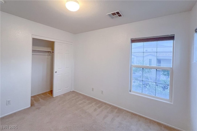 9148 Alluring Ave, Las Vegas, NV 89149 - unfurnished bedroom with multiple windows, light carpet, a closet, and baseboards