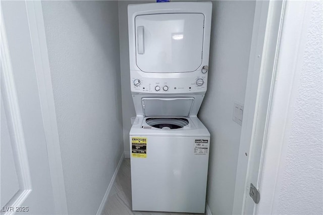 9148 Alluring Ave, Las Vegas, NV 89149 - laundry room with stacked washing machine and dryer and baseboards