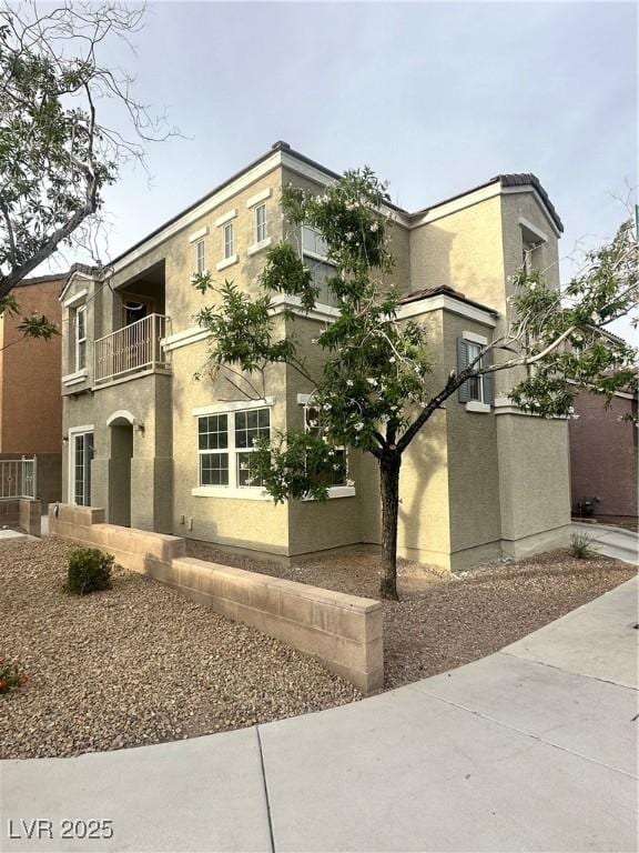 9148 Alluring Ave, Las Vegas, NV 89149 - view of front of home with a balcony and stucco siding