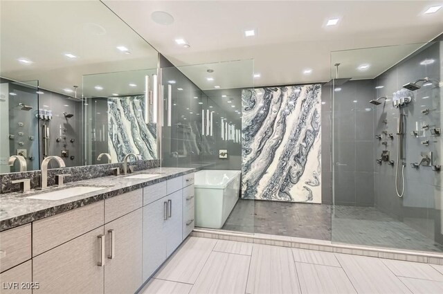 2777 Paradise Rd Unit 2701Ph, Las Vegas, NV 89109 - bathroom with a stall shower, double vanity, a soaking tub, and tile walls