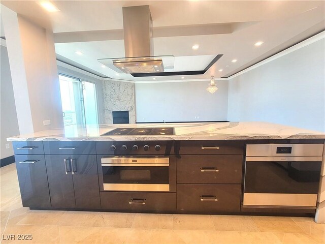 2777 Paradise Rd Unit 2701Ph, Las Vegas, NV 89109 - kitchen featuring oven, a raised ceiling, light stone countertops, and crown molding