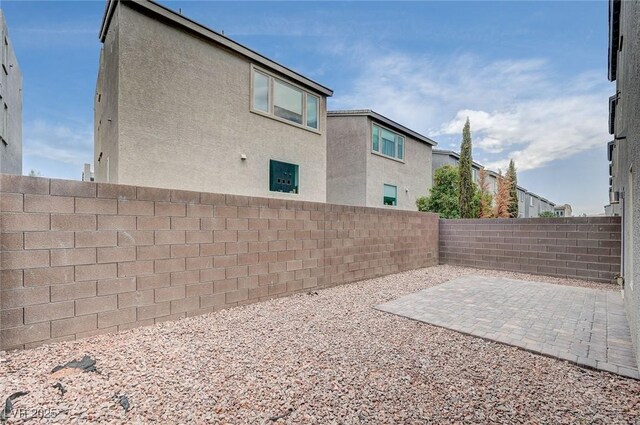 8056 Haywood Estate Ave, Las Vegas, NV 89113 - view of property exterior with a fenced backyard, stucco siding, and a patio