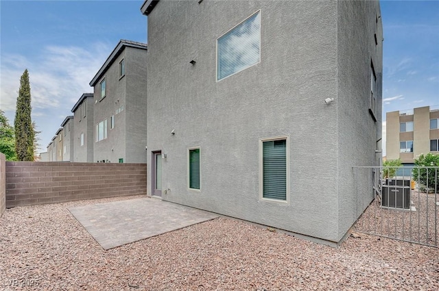 8056 Haywood Estate Ave, Las Vegas, NV 89113 - rear view of house featuring stucco siding, a fenced backyard, a patio, and central air condition unit