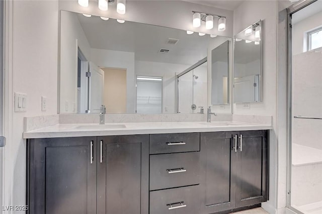 8056 Haywood Estate Ave, Las Vegas, NV 89113 - bathroom with a stall shower, double vanity, and a walk in closet