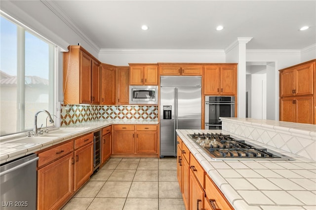 215 Great Gable Dr, Las Vegas, NV 89183 - kitchen featuring built in appliances, tile countertops, beverage cooler, backsplash, and crown molding