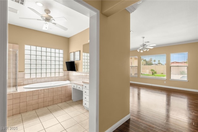 215 Great Gable Dr, Las Vegas, NV 89183 - bathroom with a ceiling fan, a garden tub, baseboards, wood finished floors, and vanity